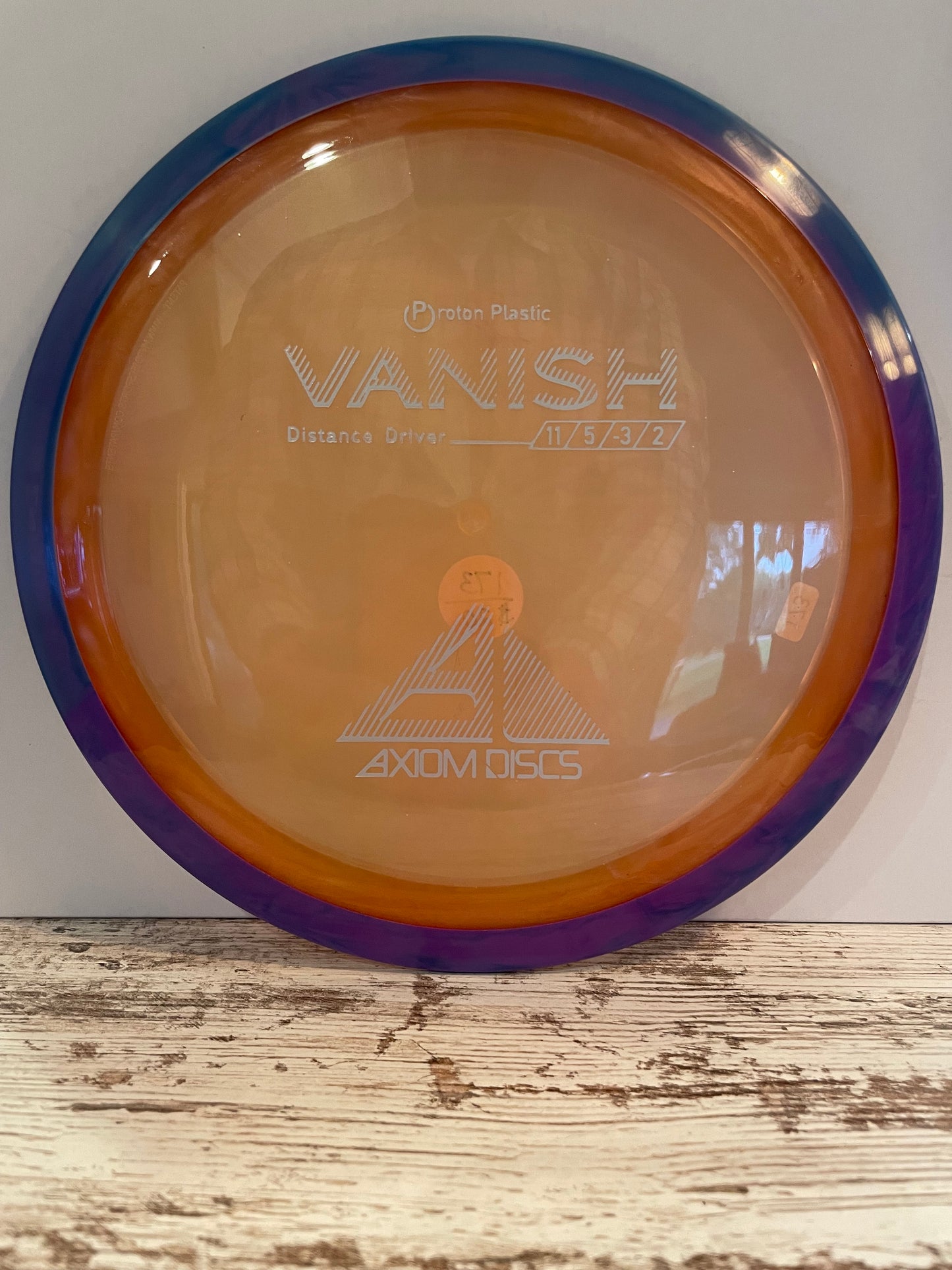 Axiom Vanish Proton 173g Orange w/ Purple Swirl Rim Distance Driver